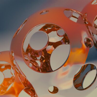 A close up of three shiny objects on a white surface