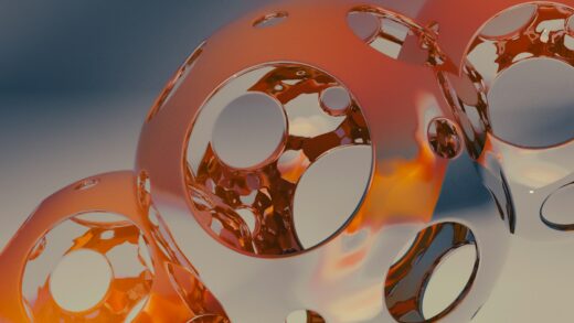 A close up of three shiny objects on a white surface